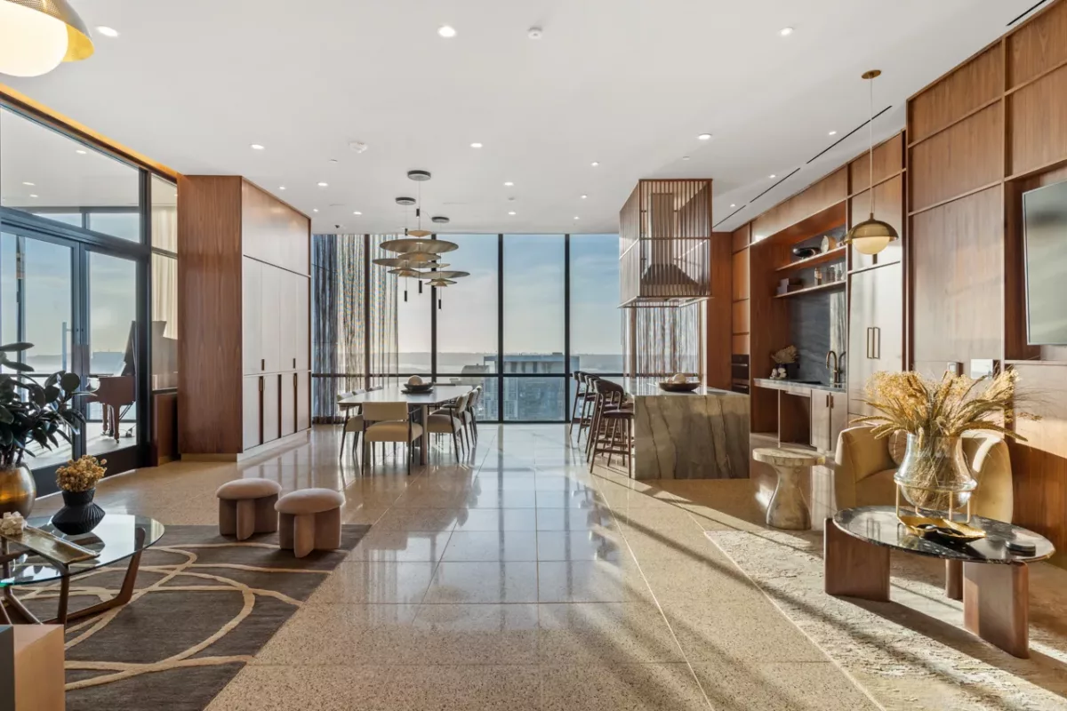 Sky lounge with dining table, kitchen island, and floor-to-ceiling ocean view.