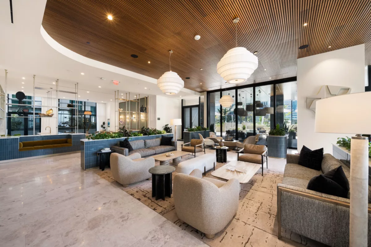 Elegant clubroom with wood ceiling, mixed seating, and decorative open shelving.