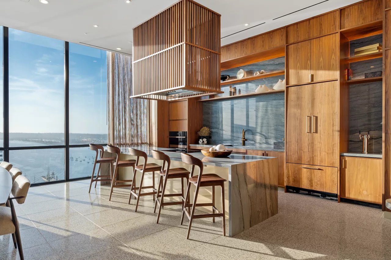 Sky lounge kitchen and dining area at dusk with large windows and modern lighting.